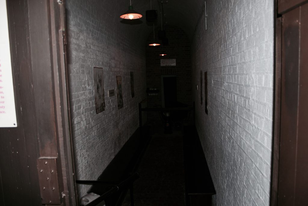 A long, dimly lit corridor inside Newhaven Fort at night
